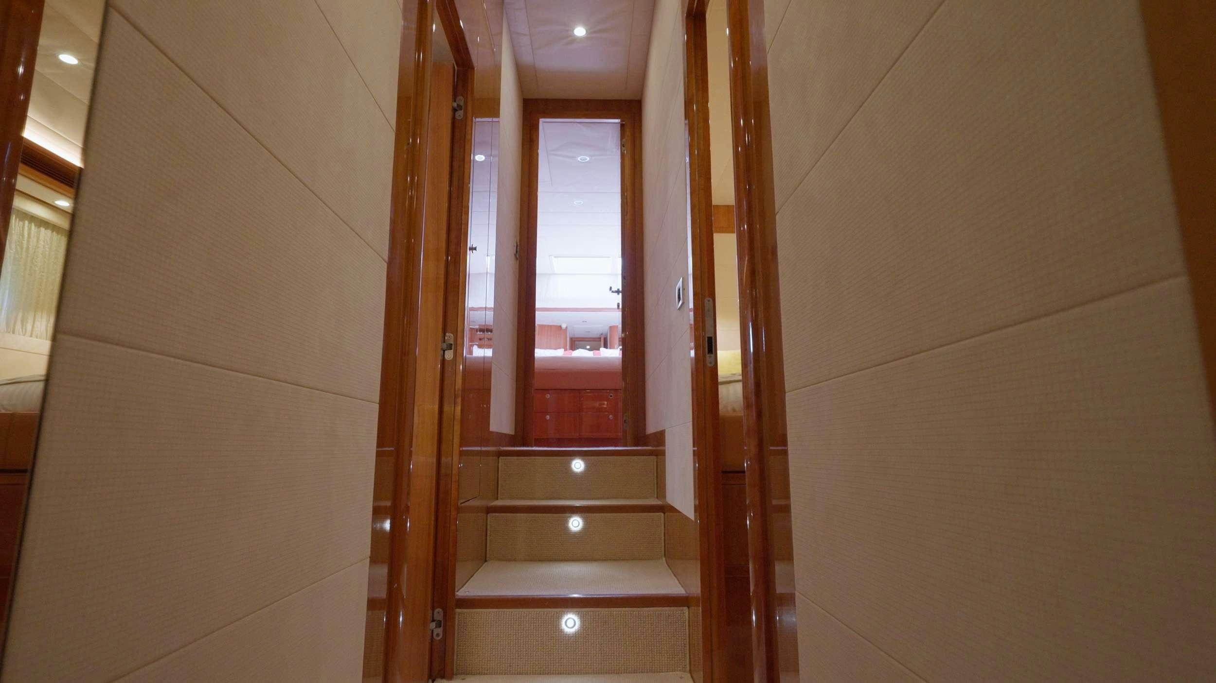 a room with wooden stairs aboard NATASSA ( EX LADY NATASA) Yacht for Charter