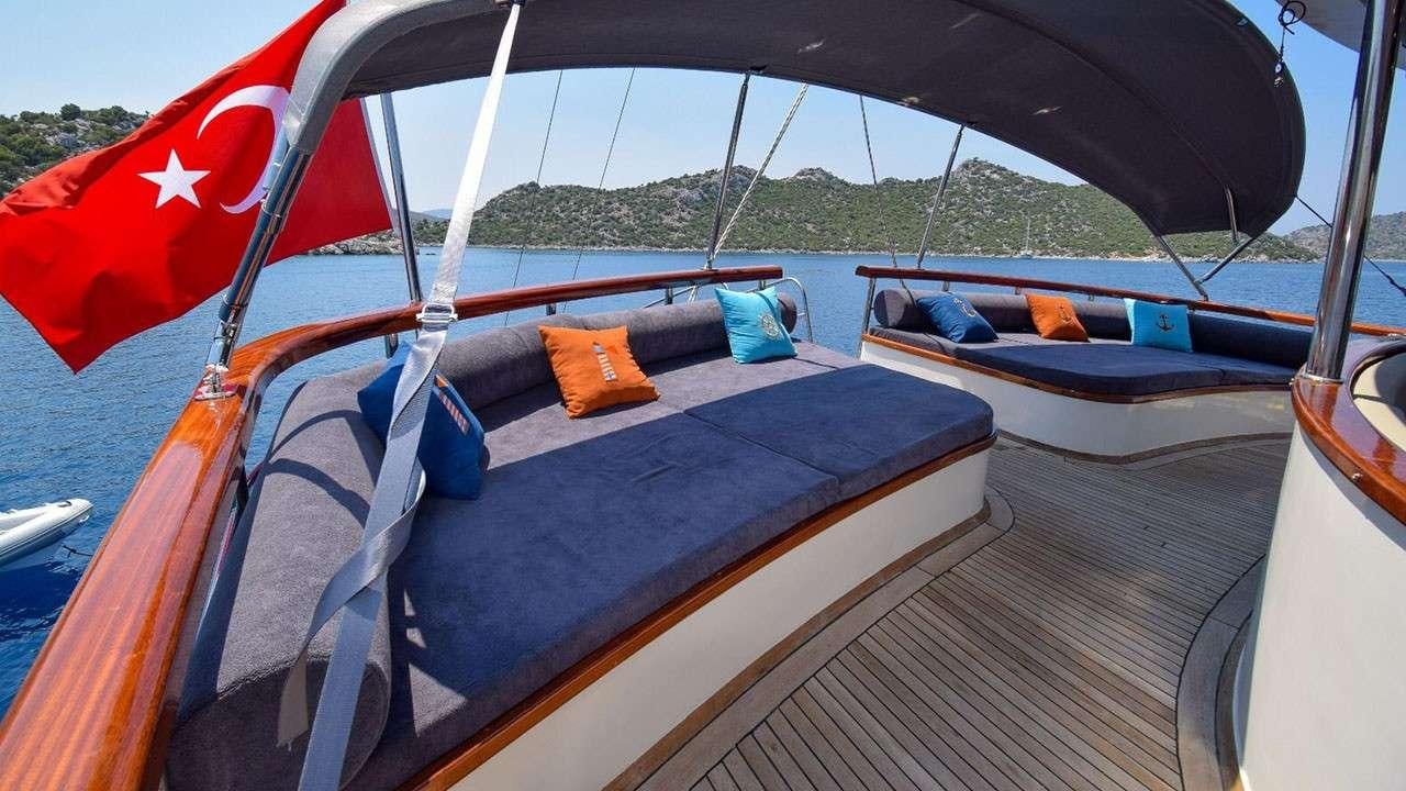 a boat with a flag on the front aboard BABACAN Yacht for Charter
