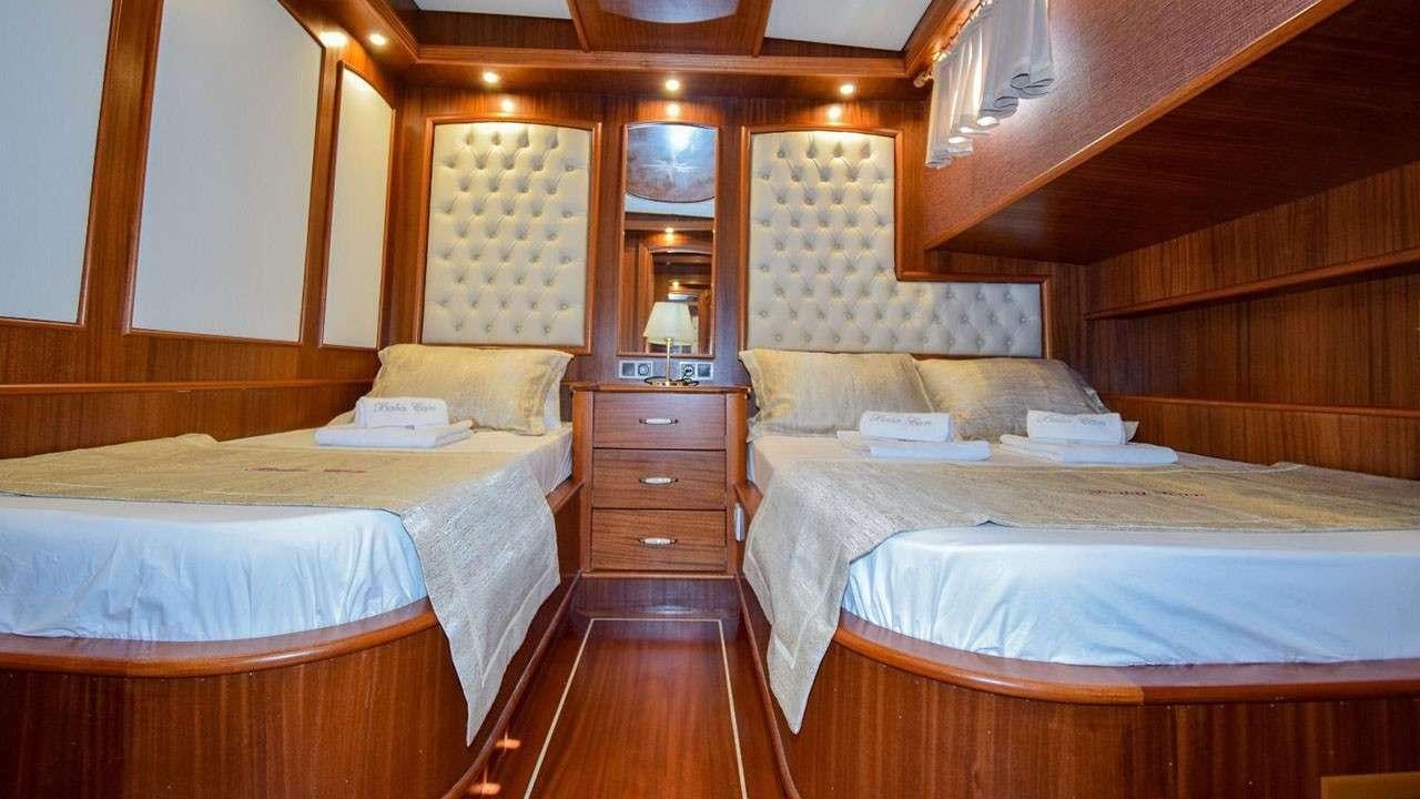 a couple of beds in a hotel room aboard BABACAN Yacht for Charter