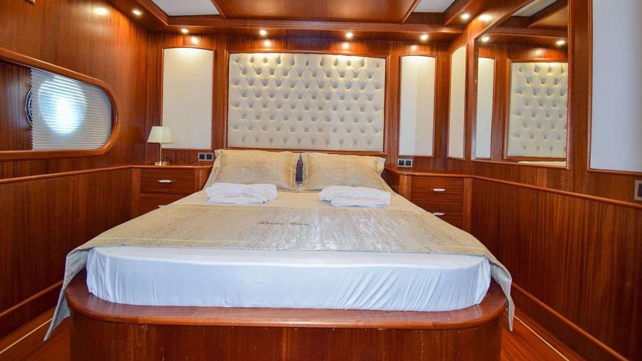 a bed with a white sheet aboard BABACAN Yacht for Charter