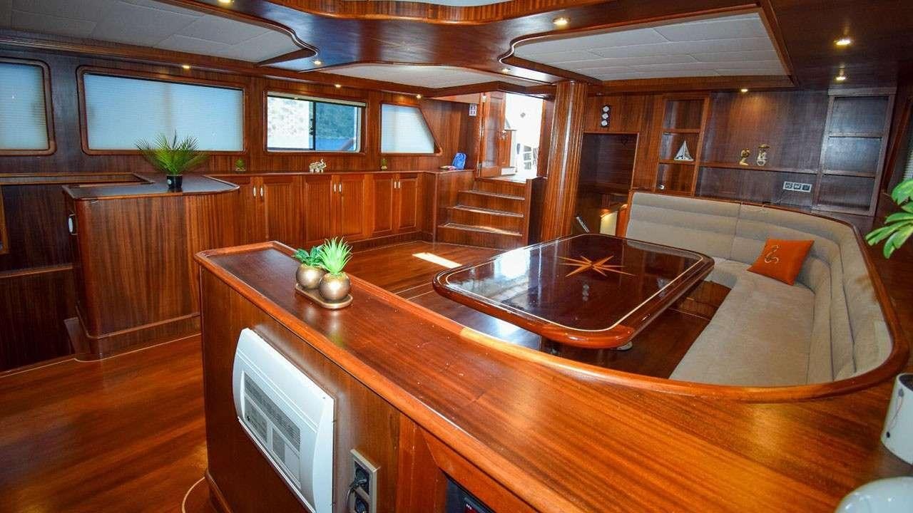 a room with a table and couch aboard BABACAN Yacht for Charter