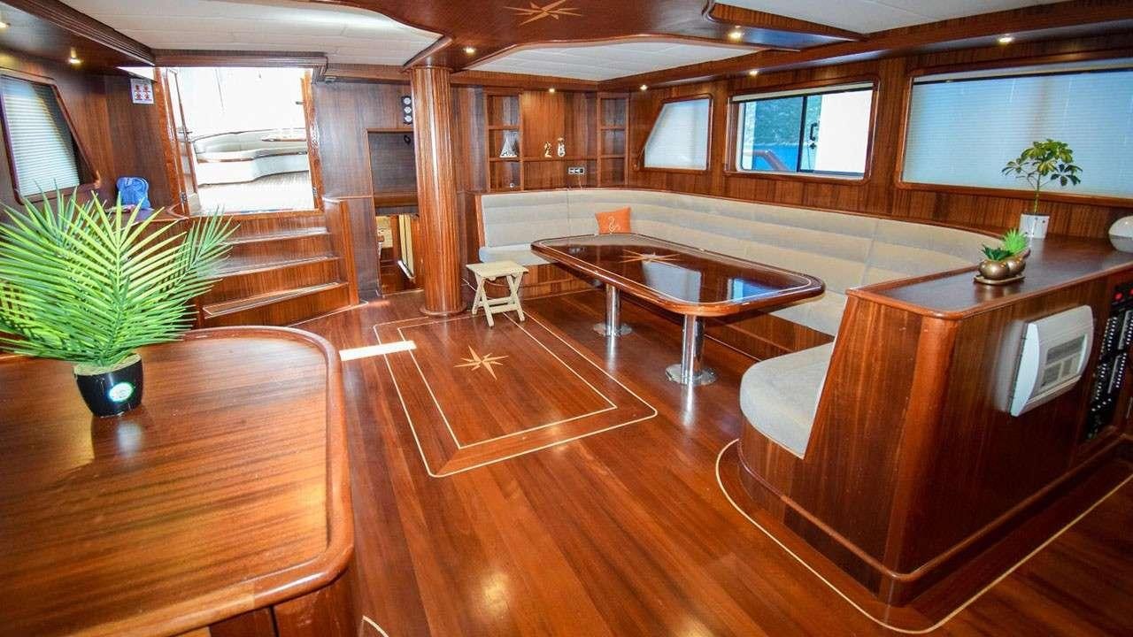 a room with wooden floors and wood cabinets aboard BABACAN Yacht for Charter