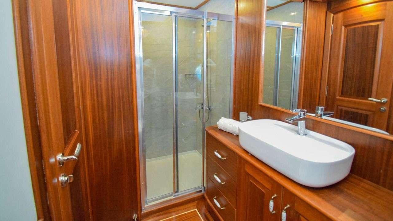 a bathroom with a glass shower aboard BABACAN Yacht for Charter