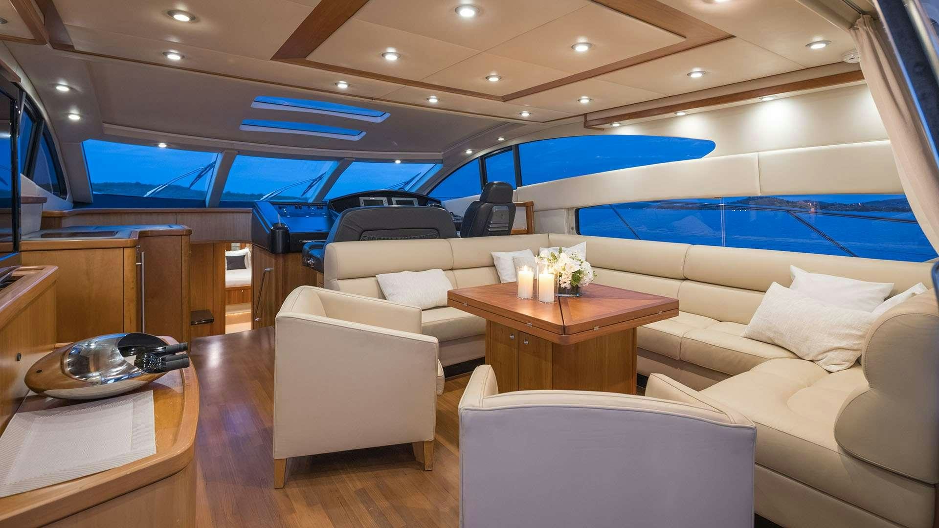 a room with a couch and a table and a pool aboard BOY TOY Yacht for Charter