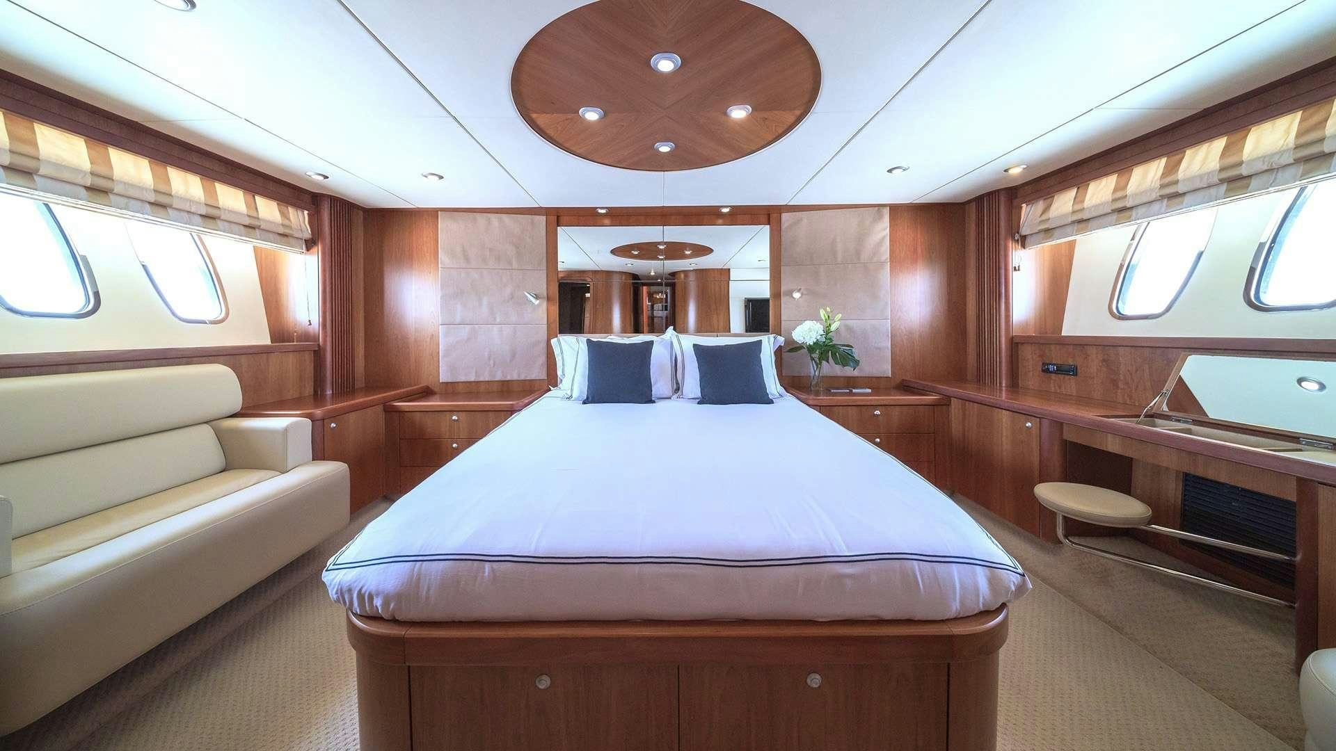 a room with a bed and a couch aboard BOY TOY Yacht for Charter