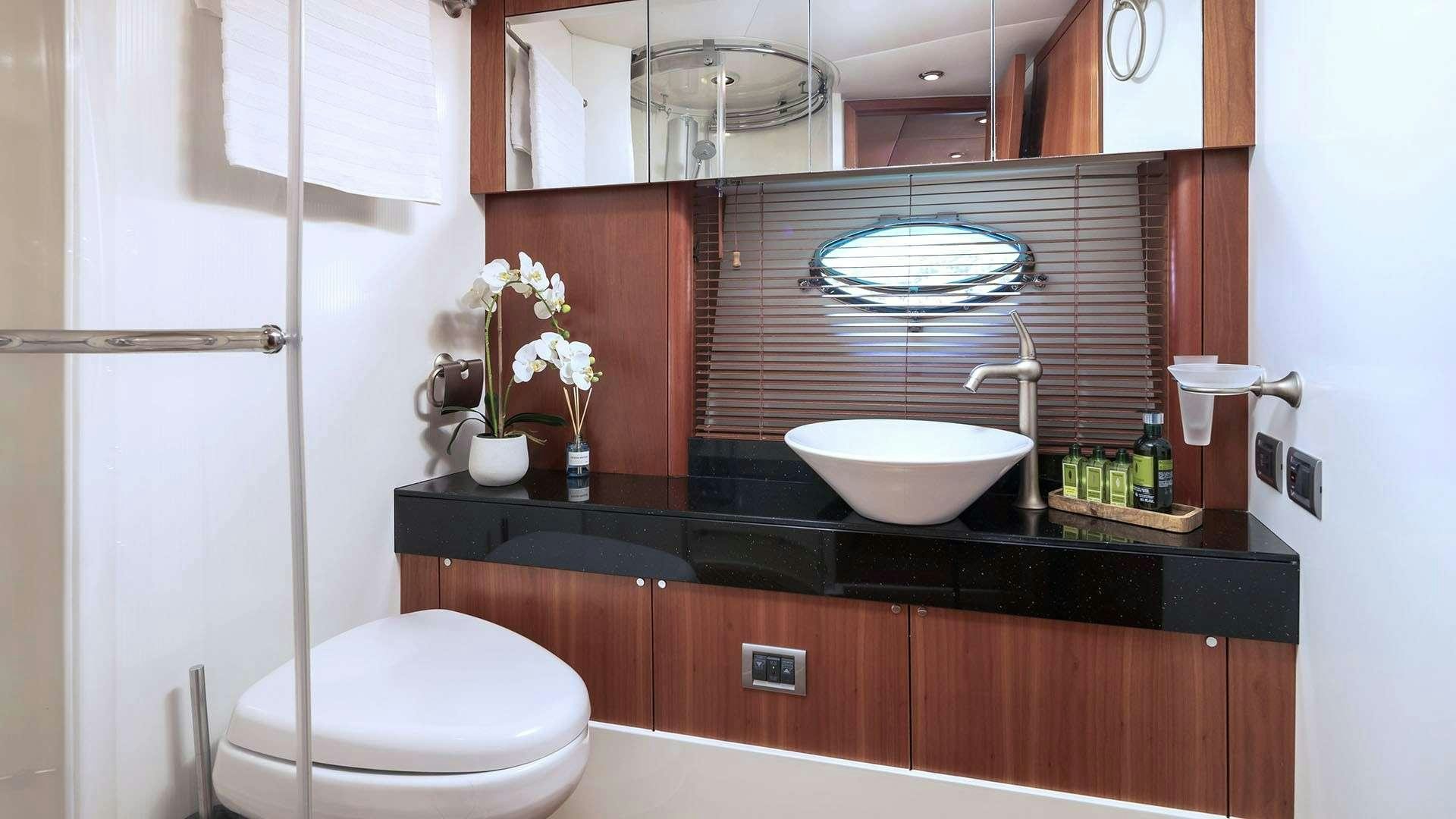 a bathroom with a large mirror aboard BOY TOY Yacht for Charter