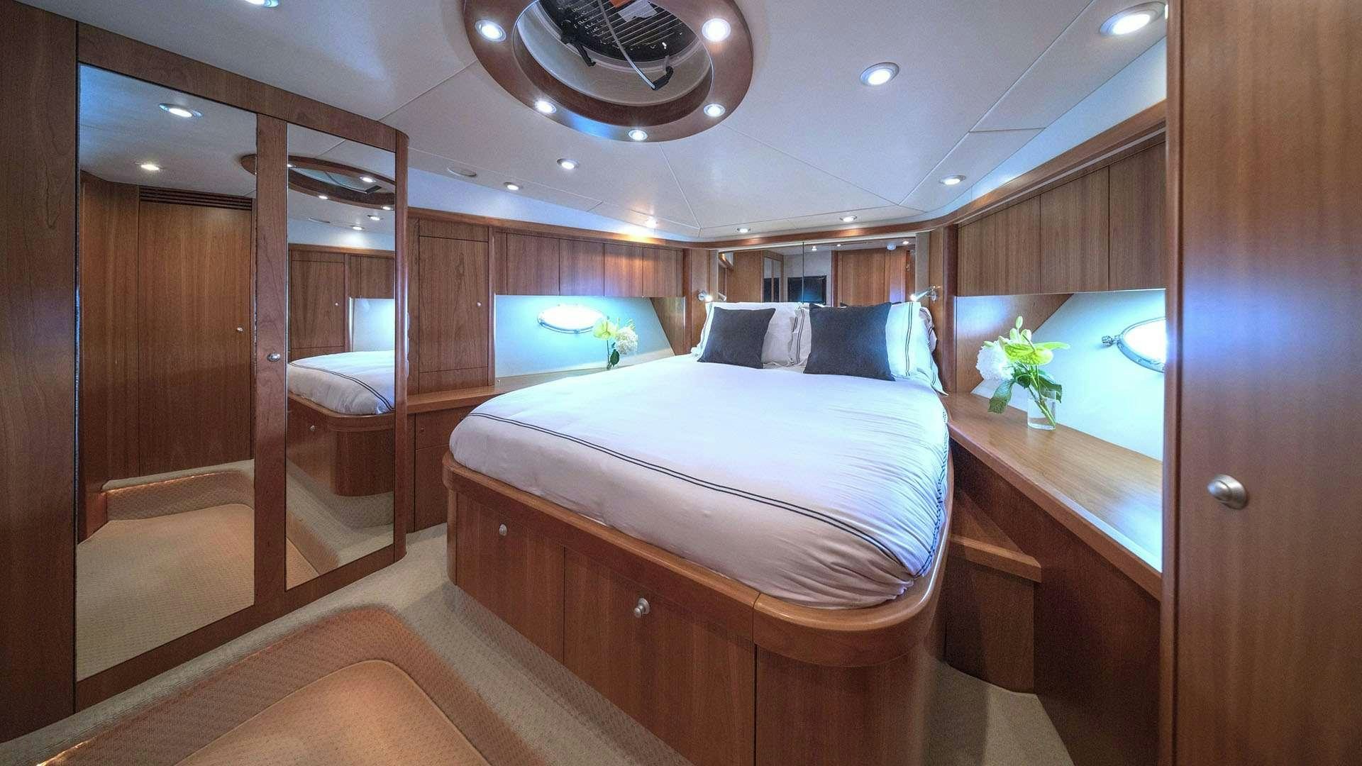 a room with a bed and a mirror aboard BOY TOY Yacht for Charter