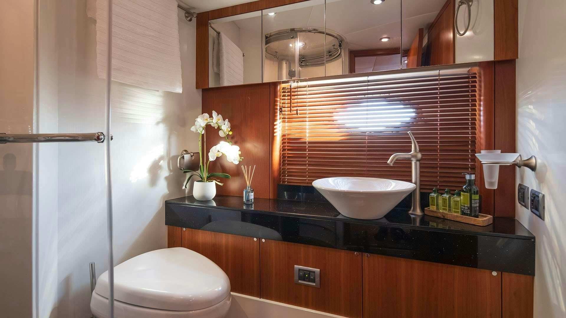 a bathroom with a sink and toilet aboard BOY TOY Yacht for Charter