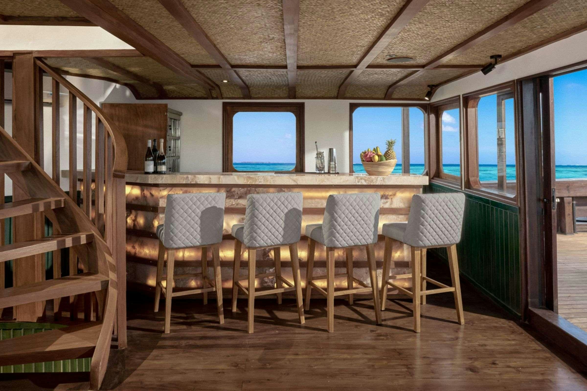 a room with a table and chairs aboard SAMSARA SAMUDRA Yacht for Charter