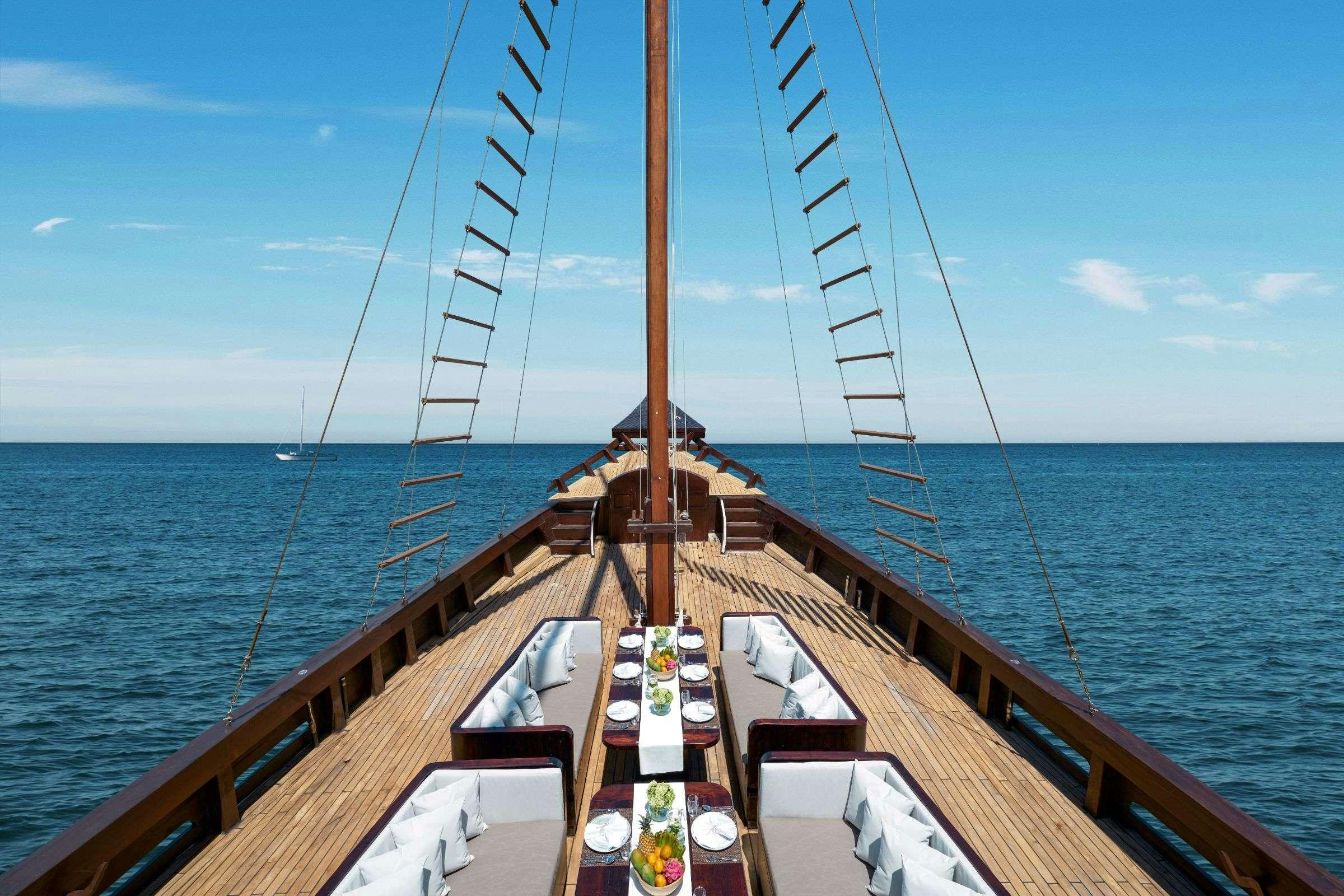 a wooden boat on the water aboard SAMSARA SAMUDRA Yacht for Charter