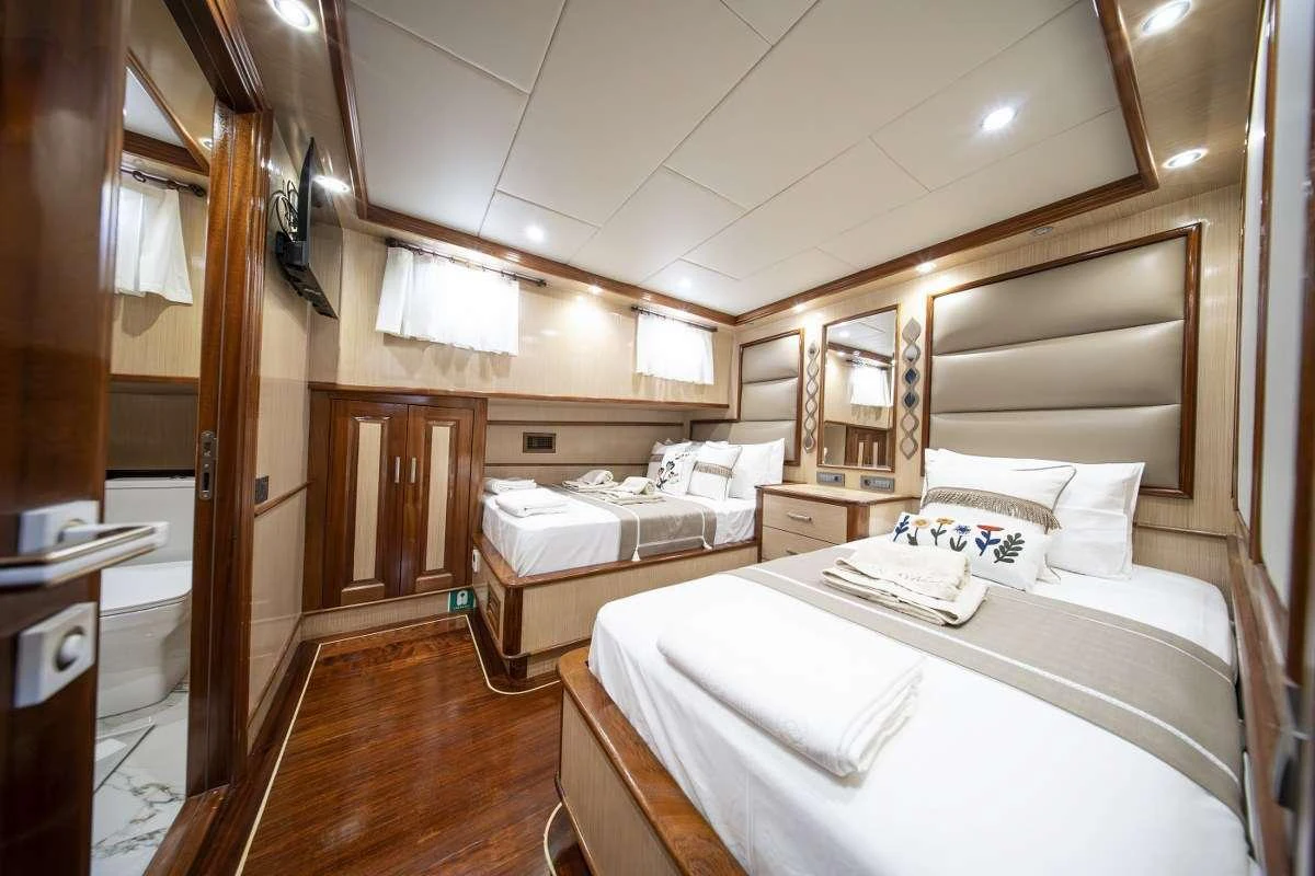 a room with a bed and a mirror aboard KAAN AYAZ Yacht for Charter