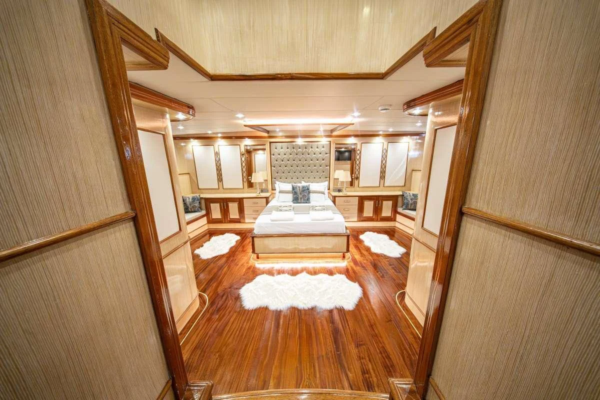 a room with a wood floor and a couch aboard KAAN AYAZ Yacht for Charter