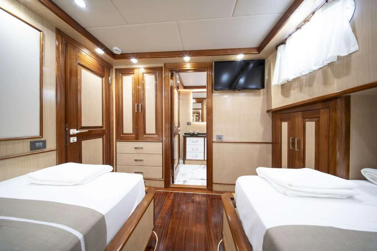 a room with a bed and a closet aboard KAAN AYAZ Yacht for Charter