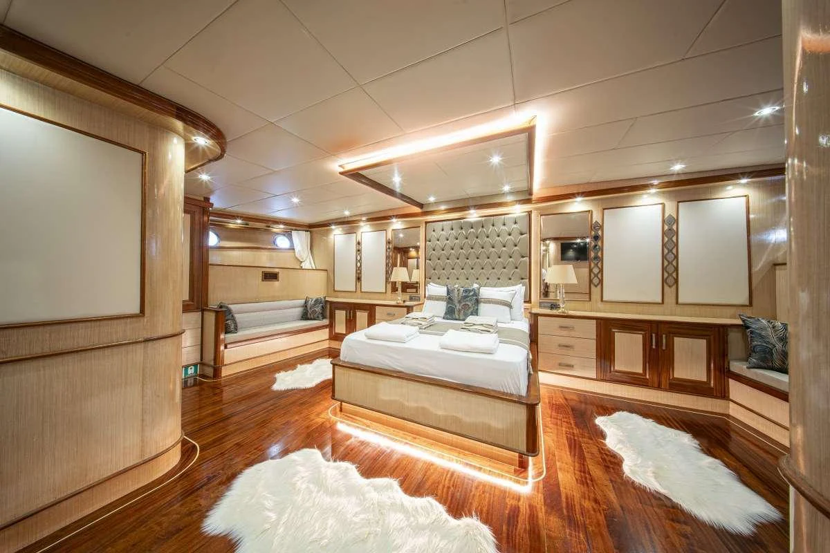 a room with a bed and a mirror aboard KAAN AYAZ Yacht for Charter