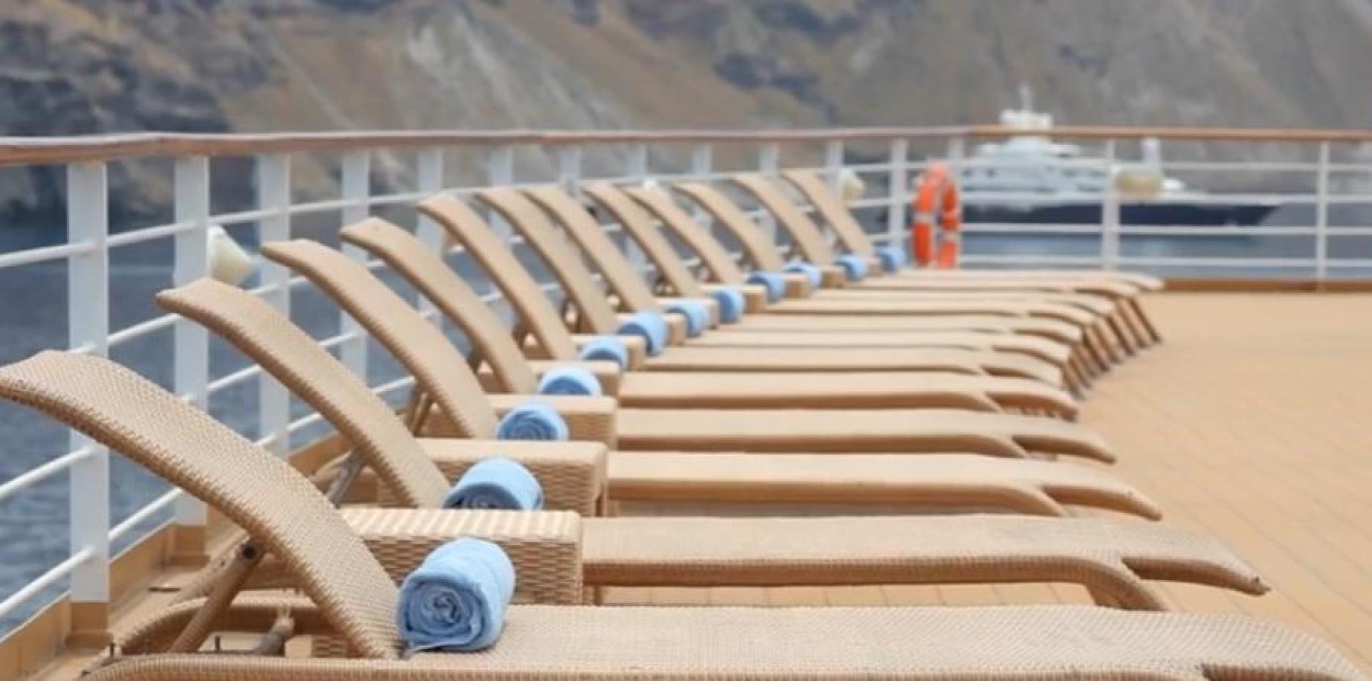 a wooden deck with a person in orange aboard AEGEAN PARADISE Yacht for Sale