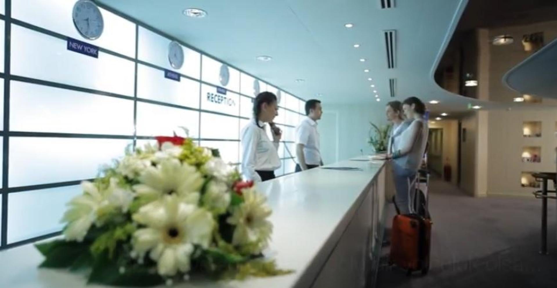 a group of people standing next to a counter with flowers aboard AEGEAN PARADISE Yacht for Sale