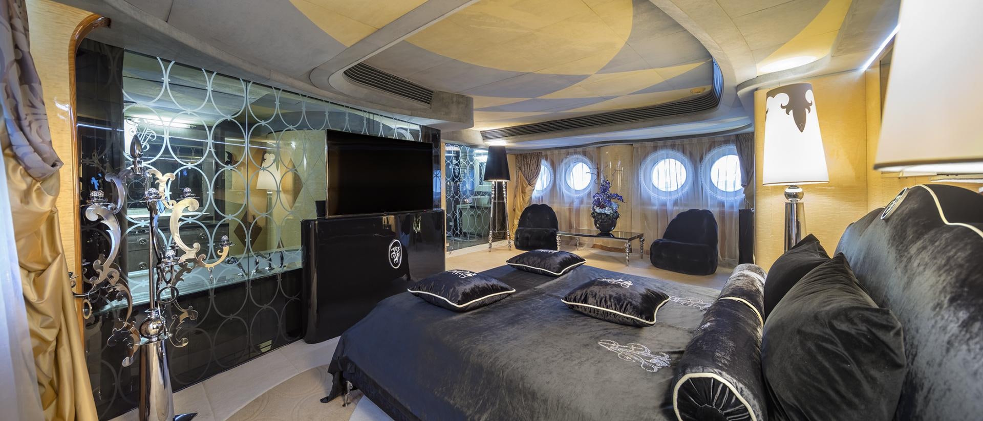 a room with a bed and a tv aboard THUNDER Yacht for Sale