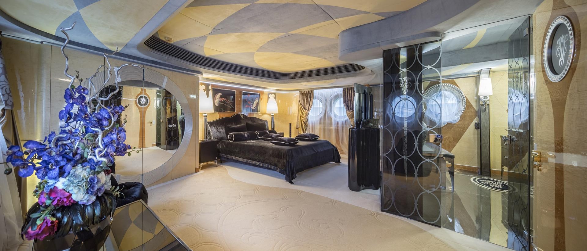 a large room with a couch and a large mirror aboard THUNDER Yacht for Sale