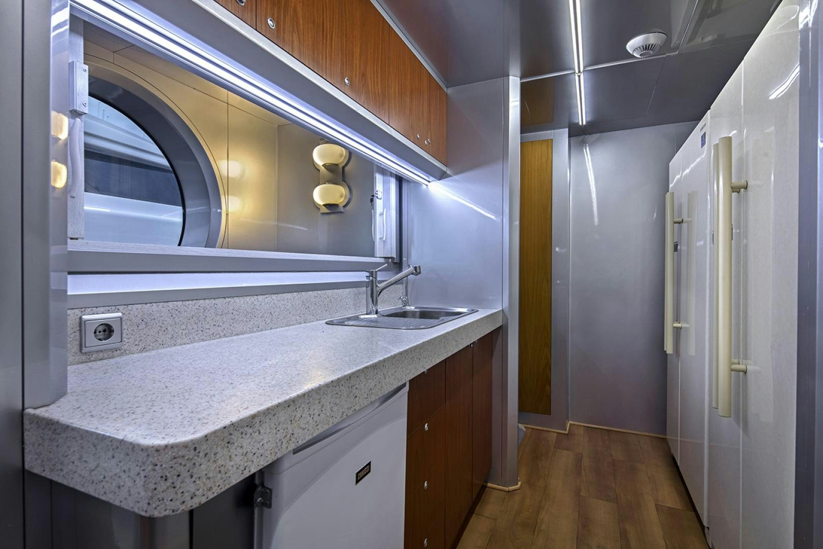a kitchen with a countertop sink and cabinets aboard THUNDER Yacht for Sale