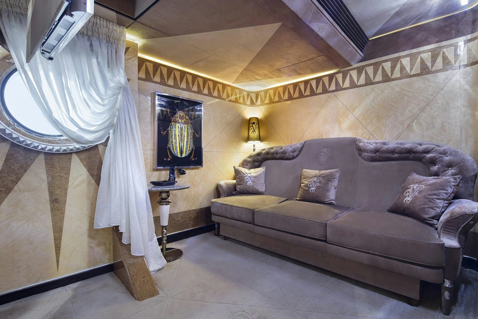 a living room with a couch and a large bed aboard THUNDER Yacht for Sale