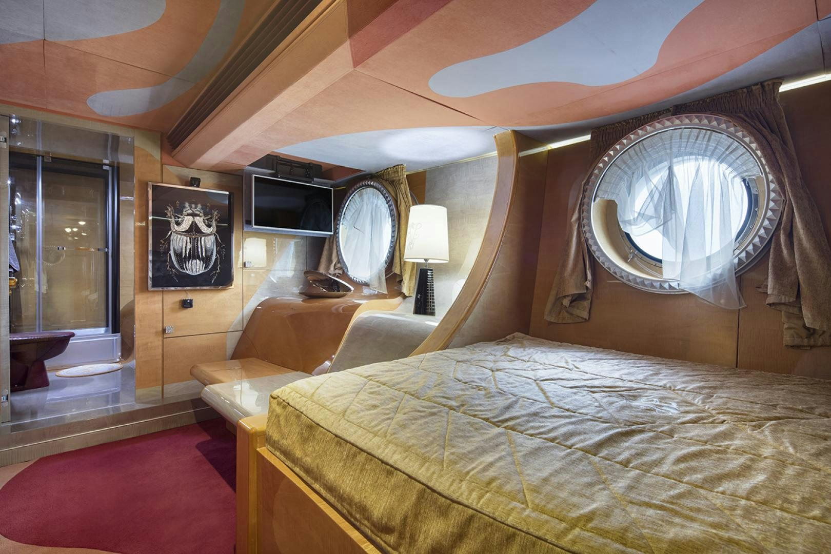 a bedroom with a bed and a mirror aboard THUNDER Yacht for Sale