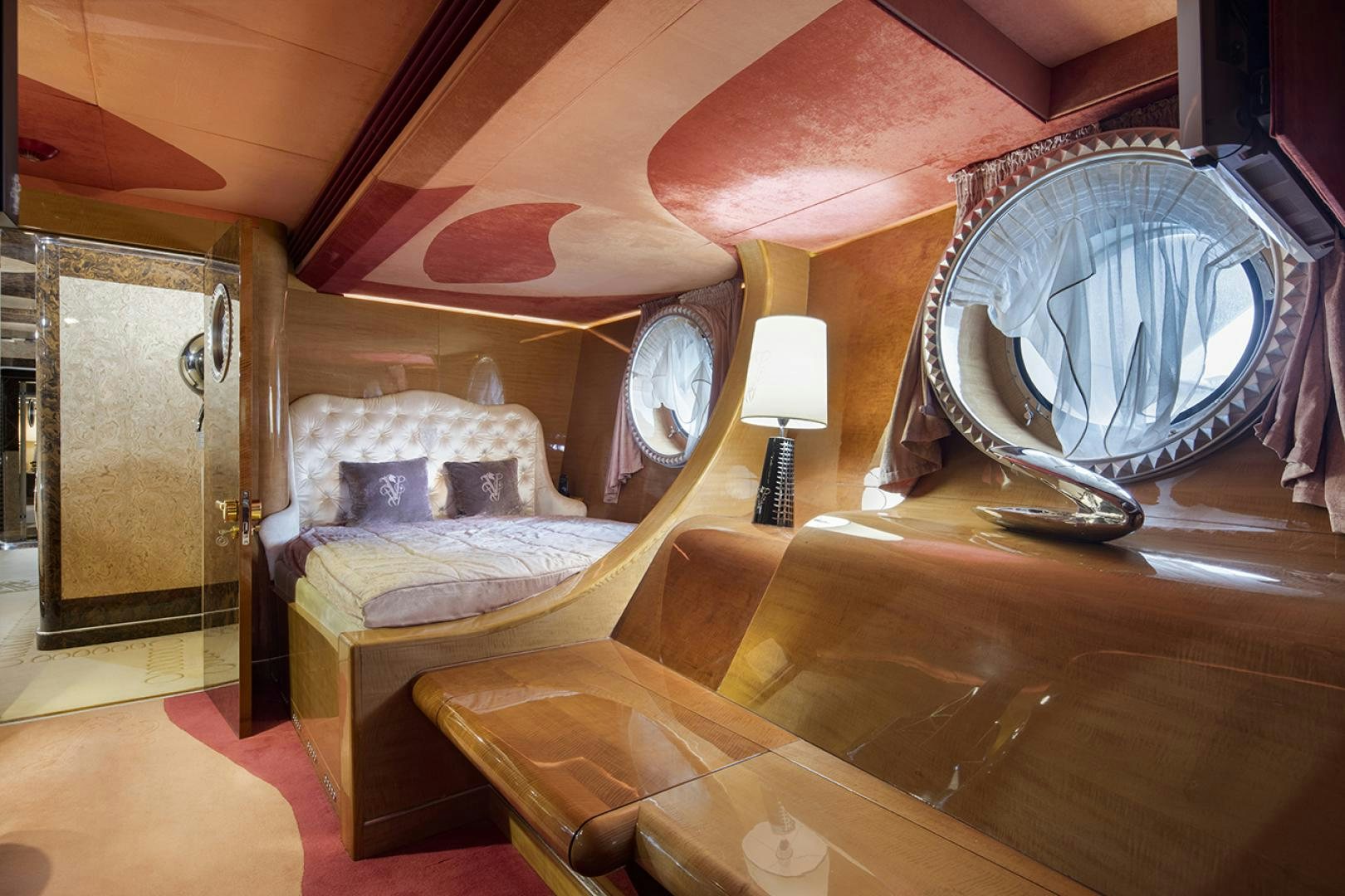 a room with a bed and a fan aboard THUNDER Yacht for Sale