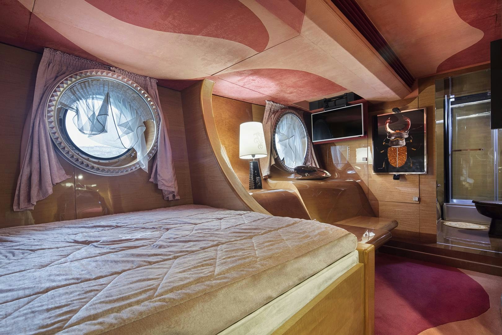 a bed with a round mirror aboard THUNDER Yacht for Sale