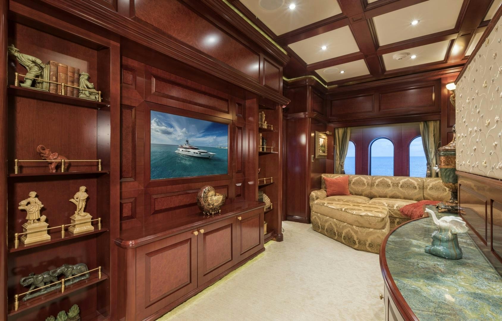 a living room with a wood cabinet aboard AMARULA SUN Yacht for Sale