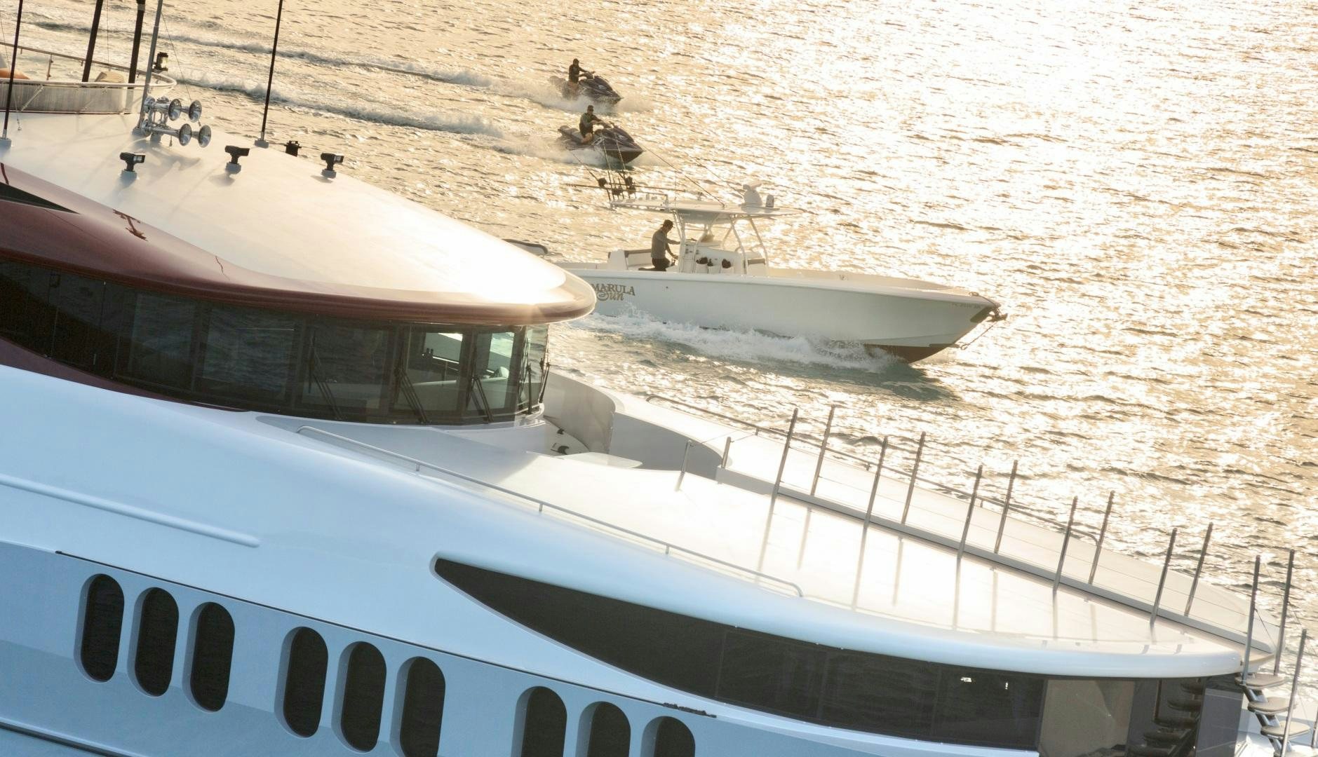 a group of birds flying over a boat on a body of water aboard AMARULA SUN Yacht for Sale