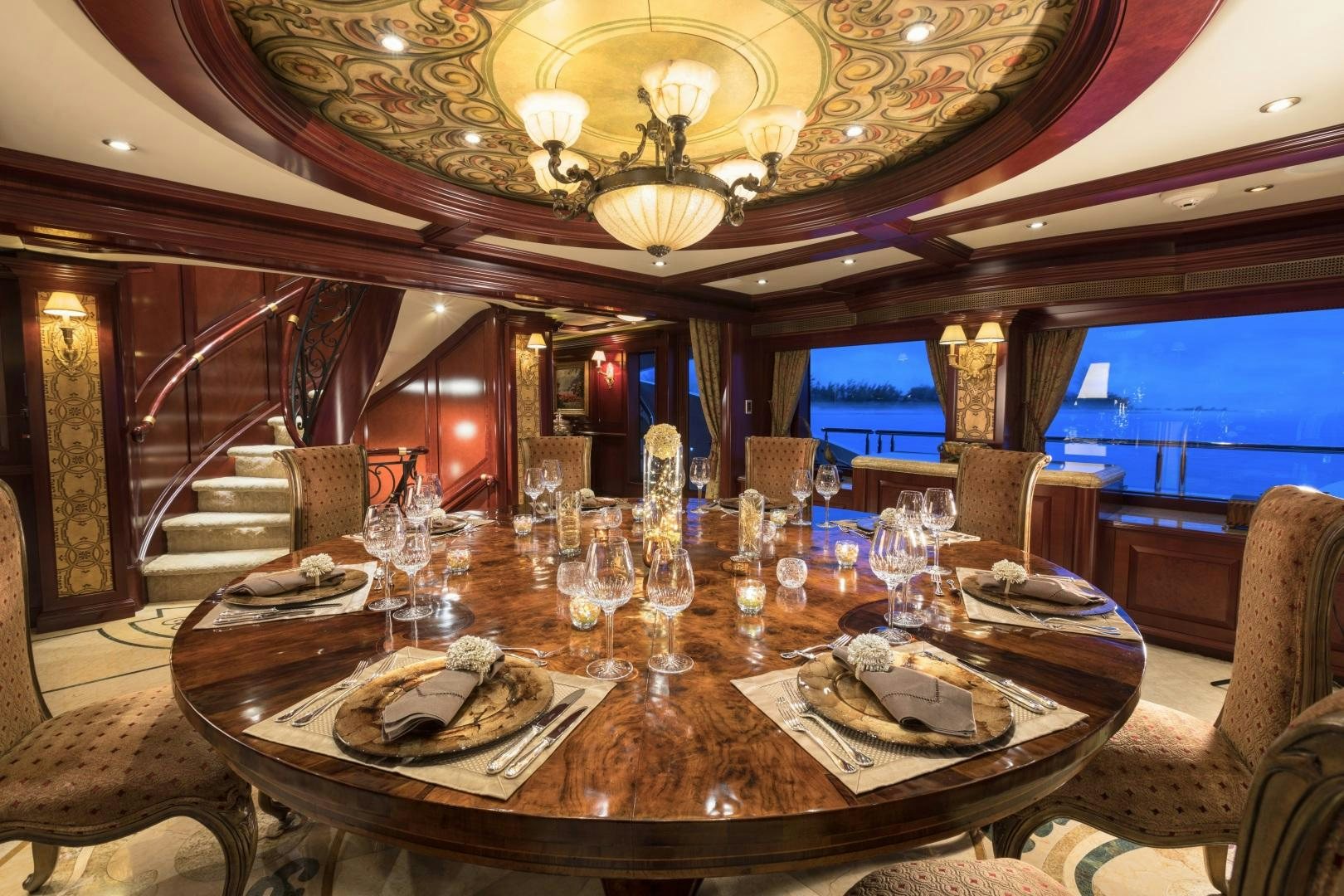 a large dining room with a chandelier aboard AMARULA SUN Yacht for Sale
