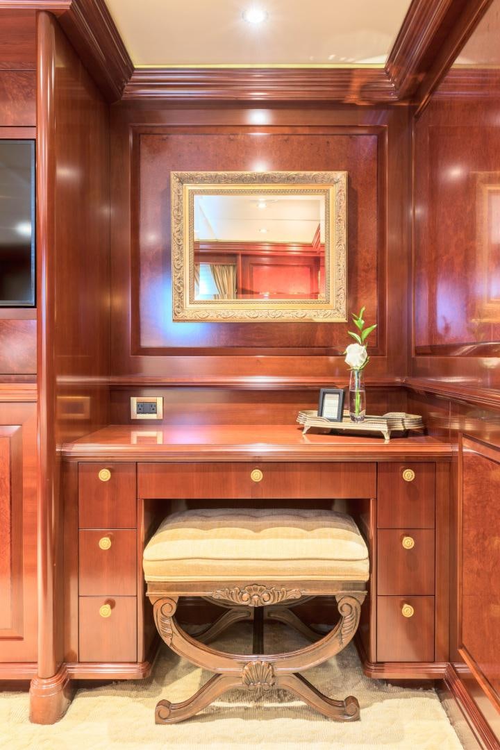 a wooden vanity with a mirror above it aboard AMARULA SUN Yacht for Sale