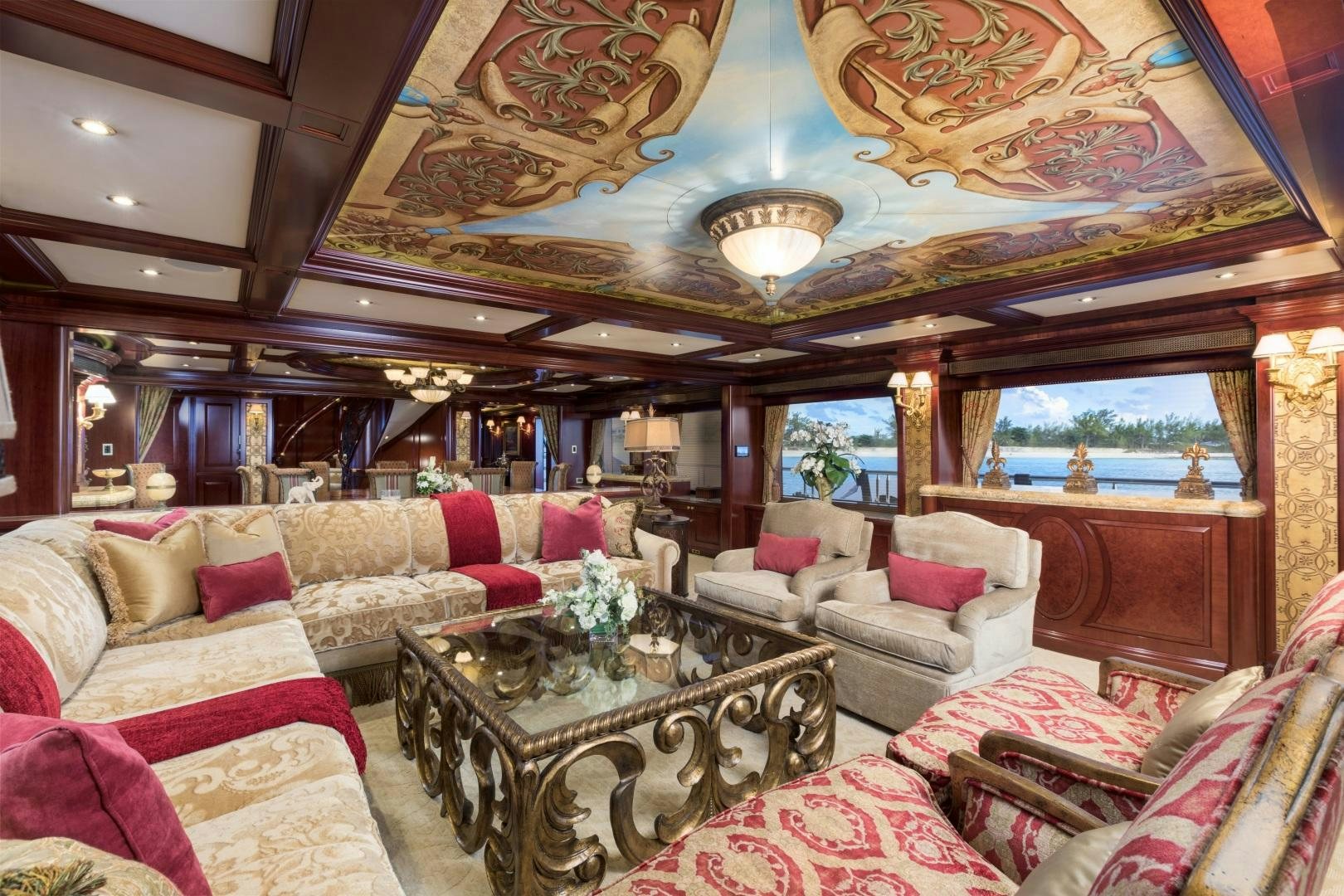 a living room with a large chandelier aboard AMARULA SUN Yacht for Sale