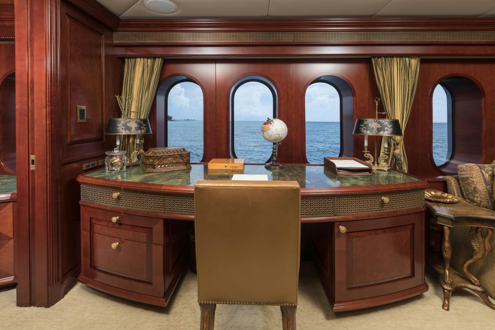 a room with a desk and a chair aboard AMARULA SUN Yacht for Sale