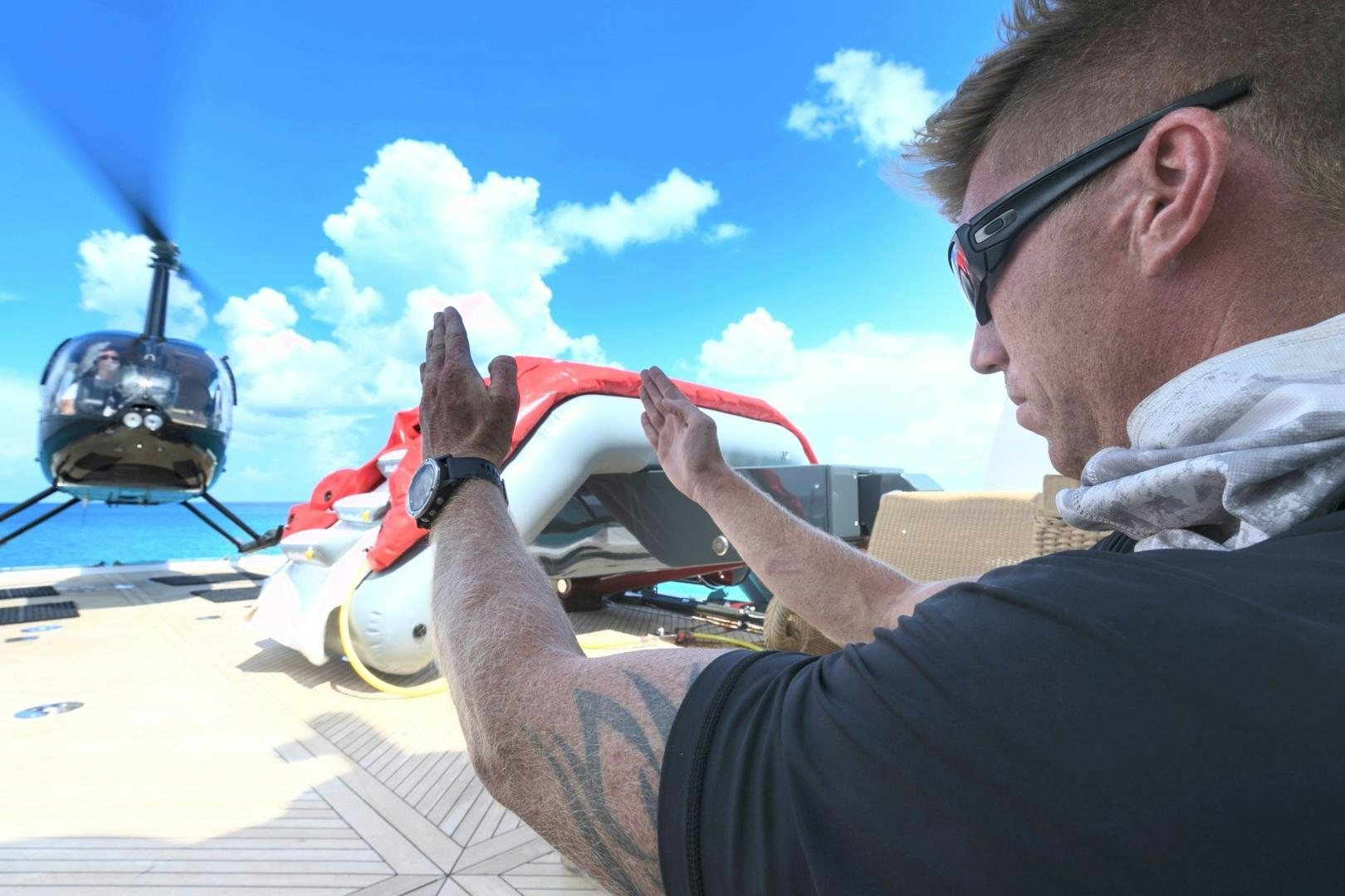 a man in a pilot's cockpit pointing a rifle aboard AMARULA SUN Yacht for Sale