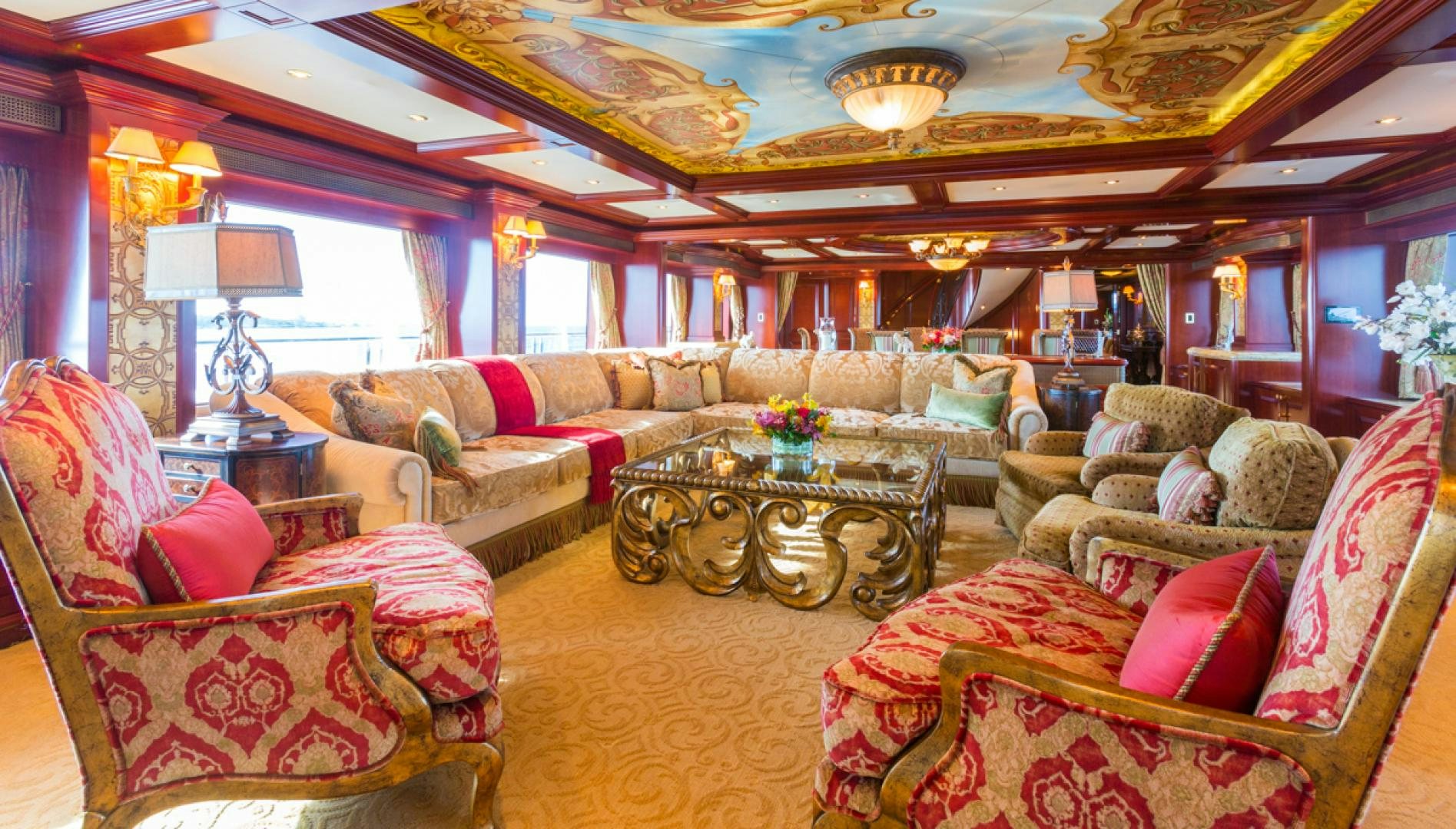 a living room with a large chandelier aboard AMARULA SUN Yacht for Sale