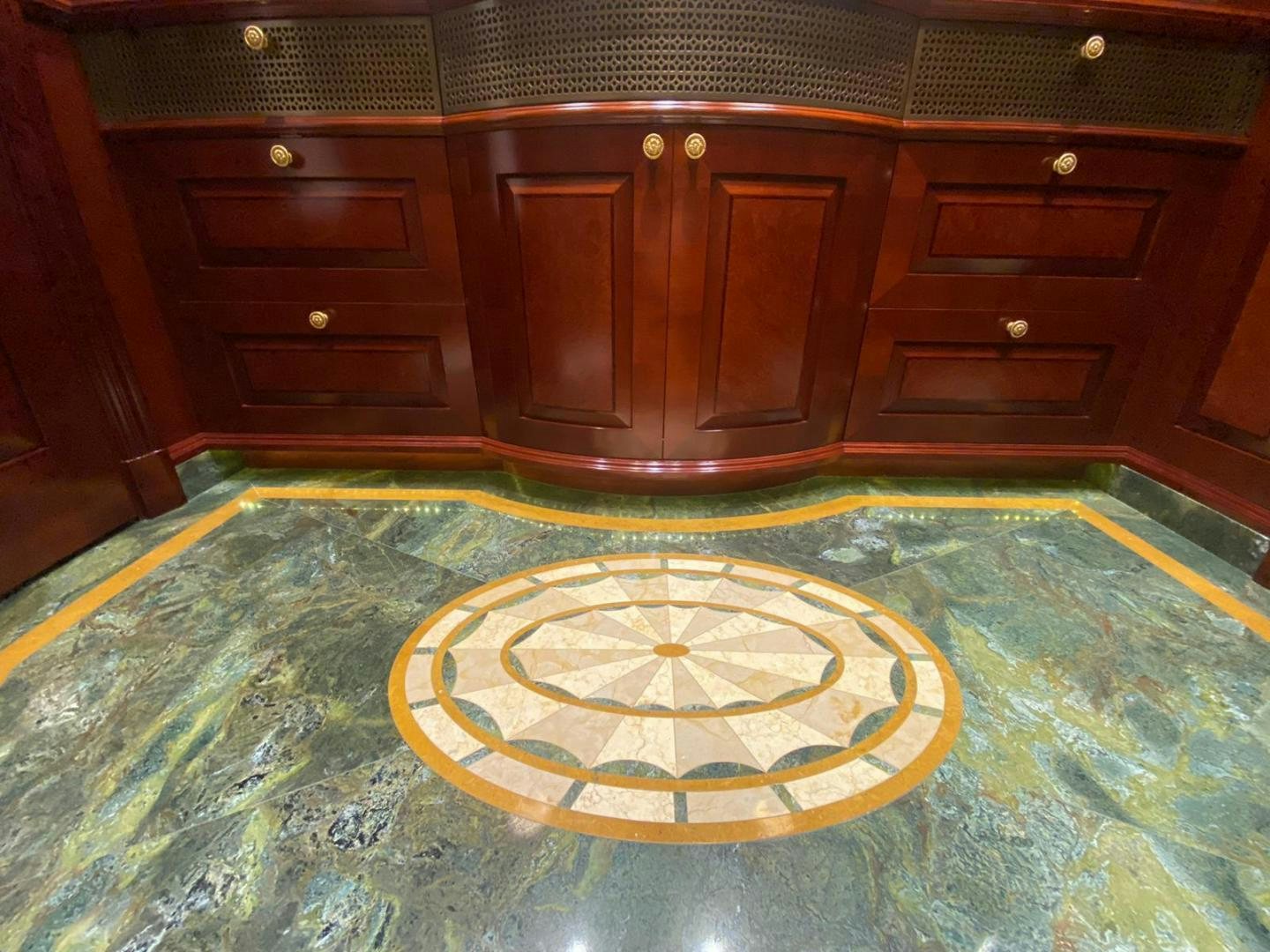 a room with a wood cabinet and a rug aboard AMARULA SUN Yacht for Sale