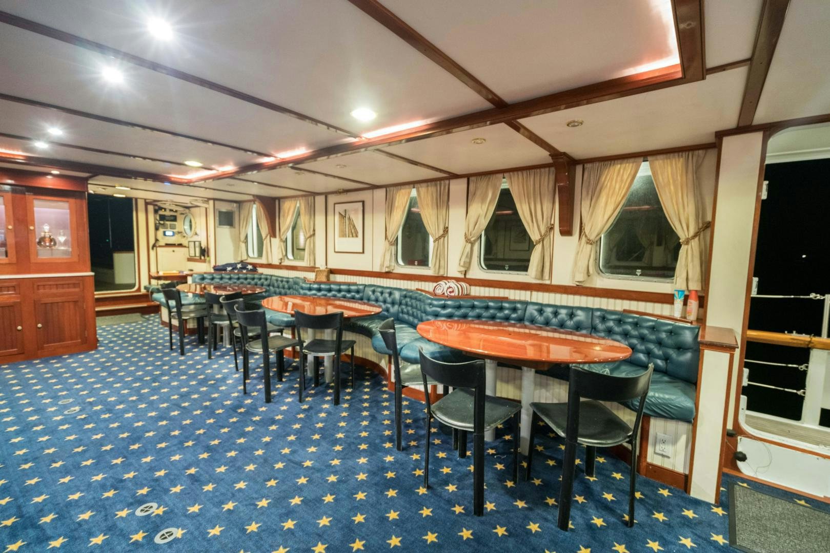 a room with tables and chairs aboard ARABELLA II Yacht for Sale