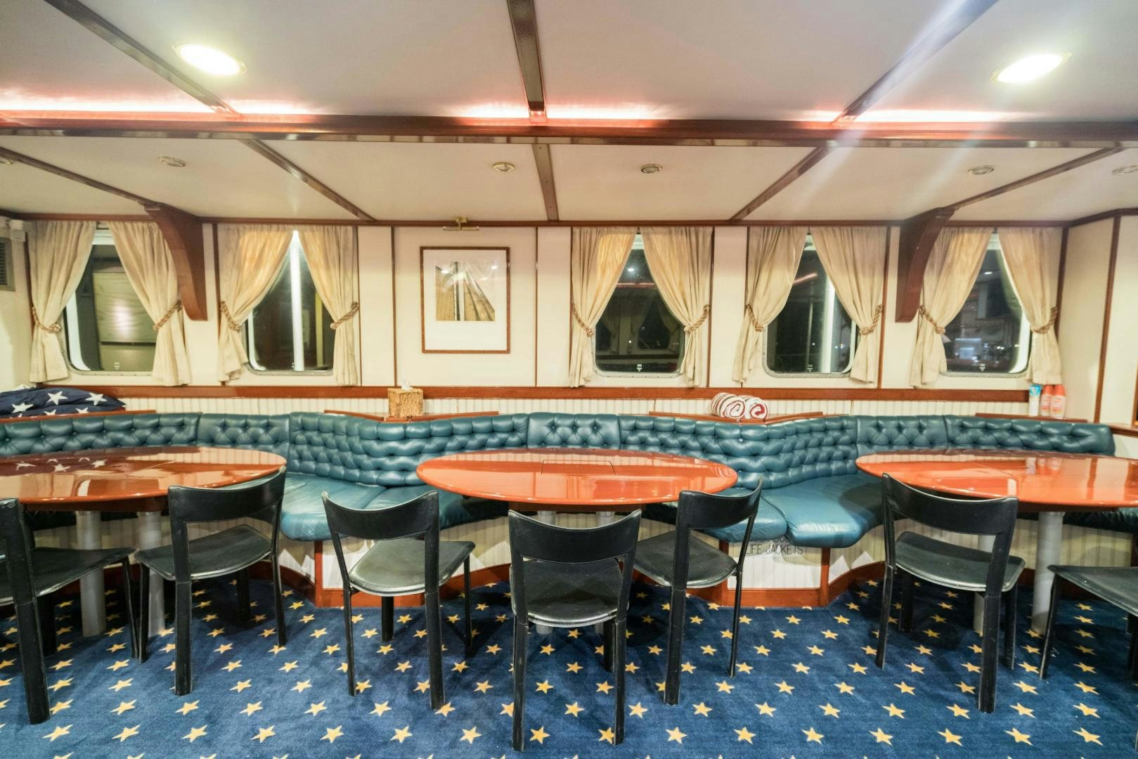 a room with tables and chairs aboard ARABELLA II Yacht for Sale