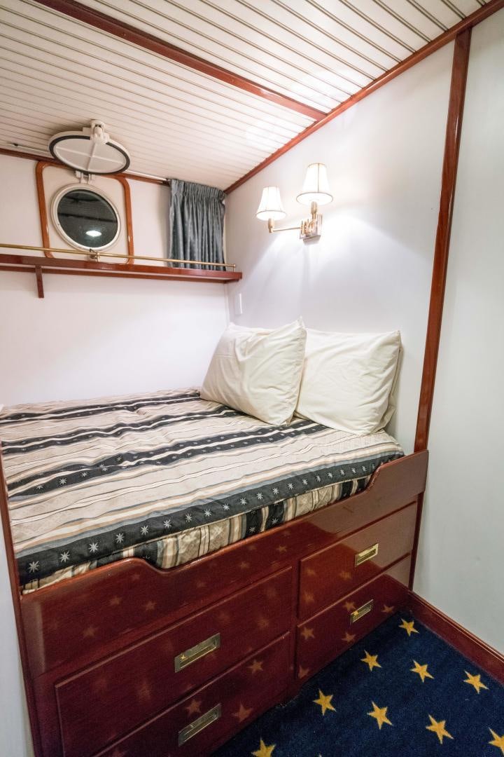 a bed with a mirror above it aboard ARABELLA II Yacht for Sale