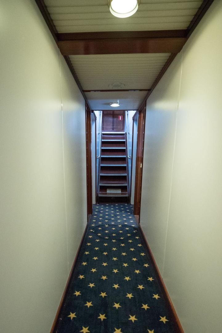 a hallway with a blue and white checkered rug aboard ARABELLA II Yacht for Sale