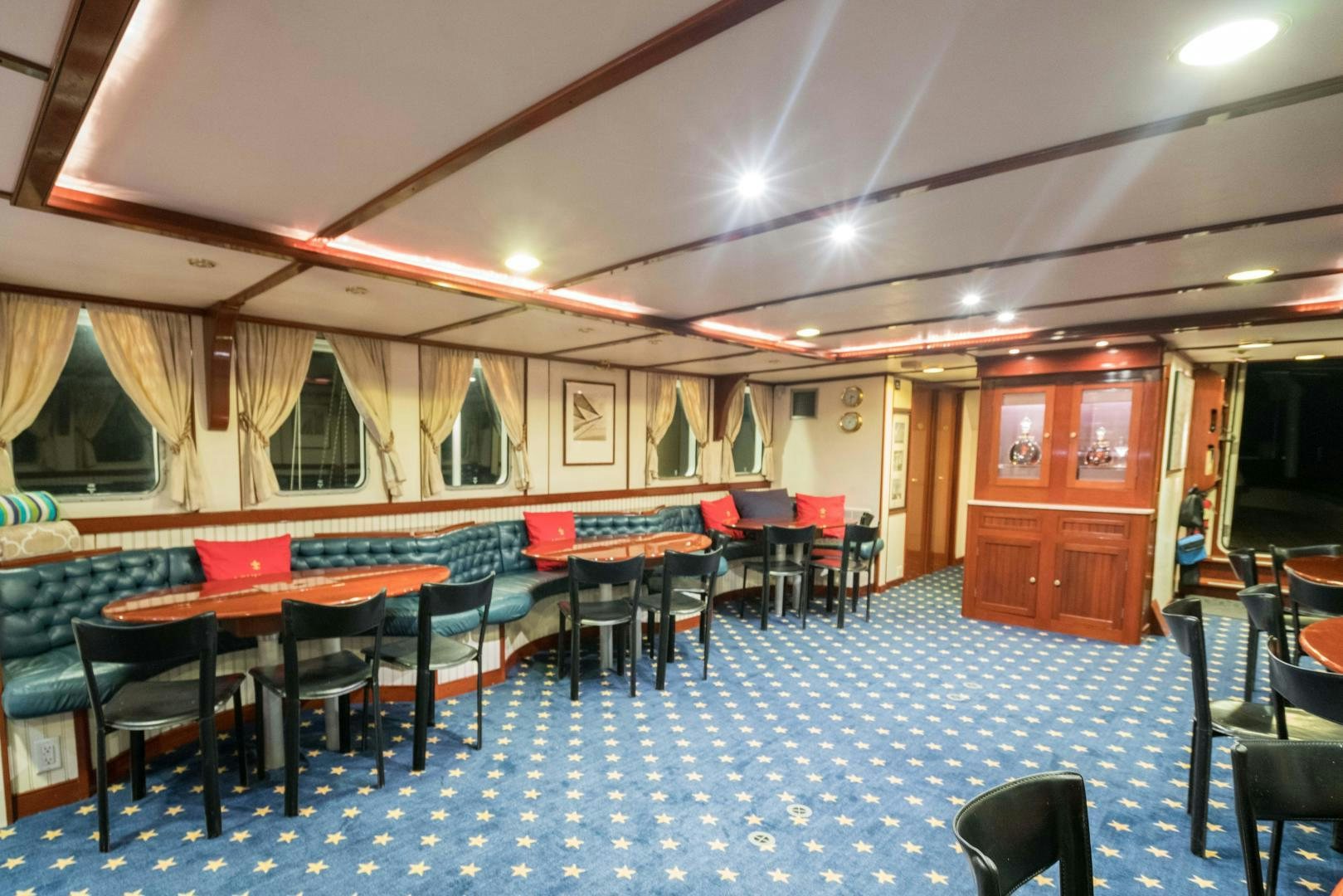 a room with tables and chairs aboard ARABELLA II Yacht for Sale