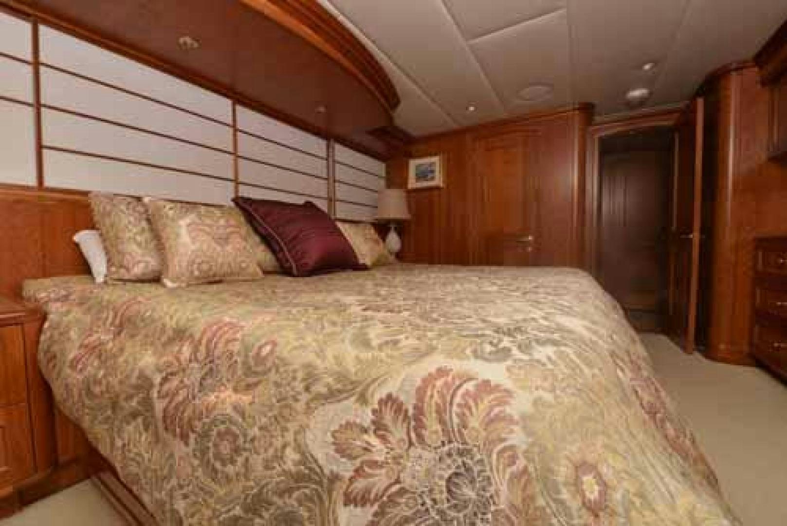 a bed with a comforter aboard UTOPIA III Yacht for Sale