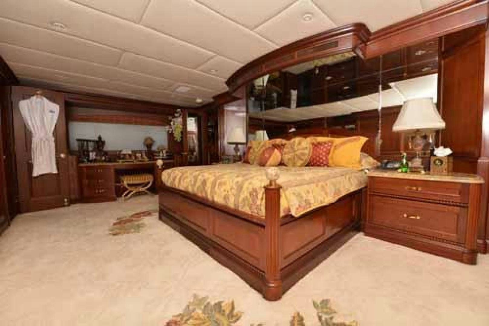 a bedroom with a bed and a desk aboard UTOPIA III Yacht for Sale