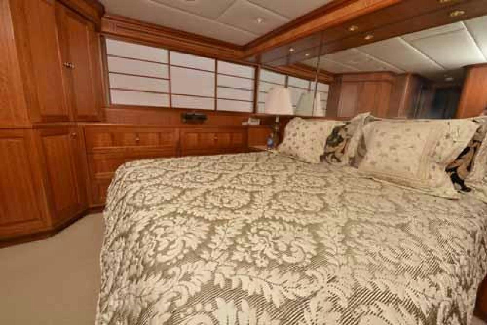 a bed with a white comforter aboard UTOPIA III Yacht for Sale