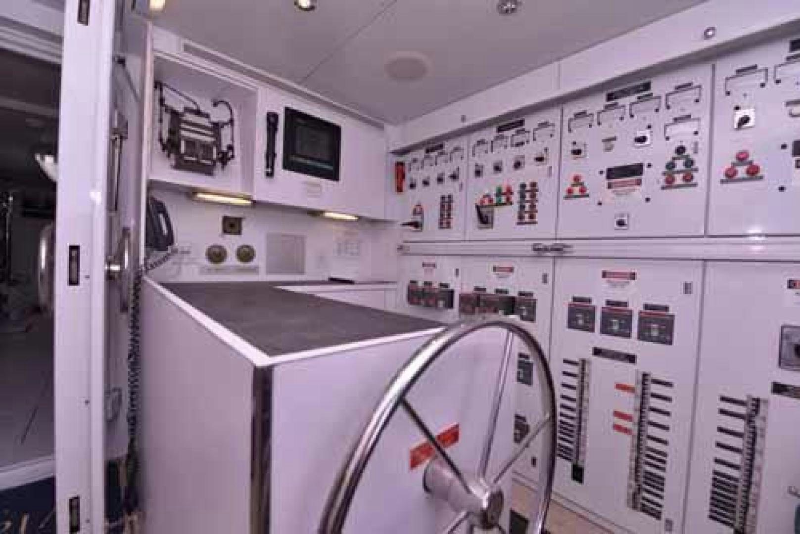 a room with white cabinets and a black counter aboard UTOPIA III Yacht for Sale