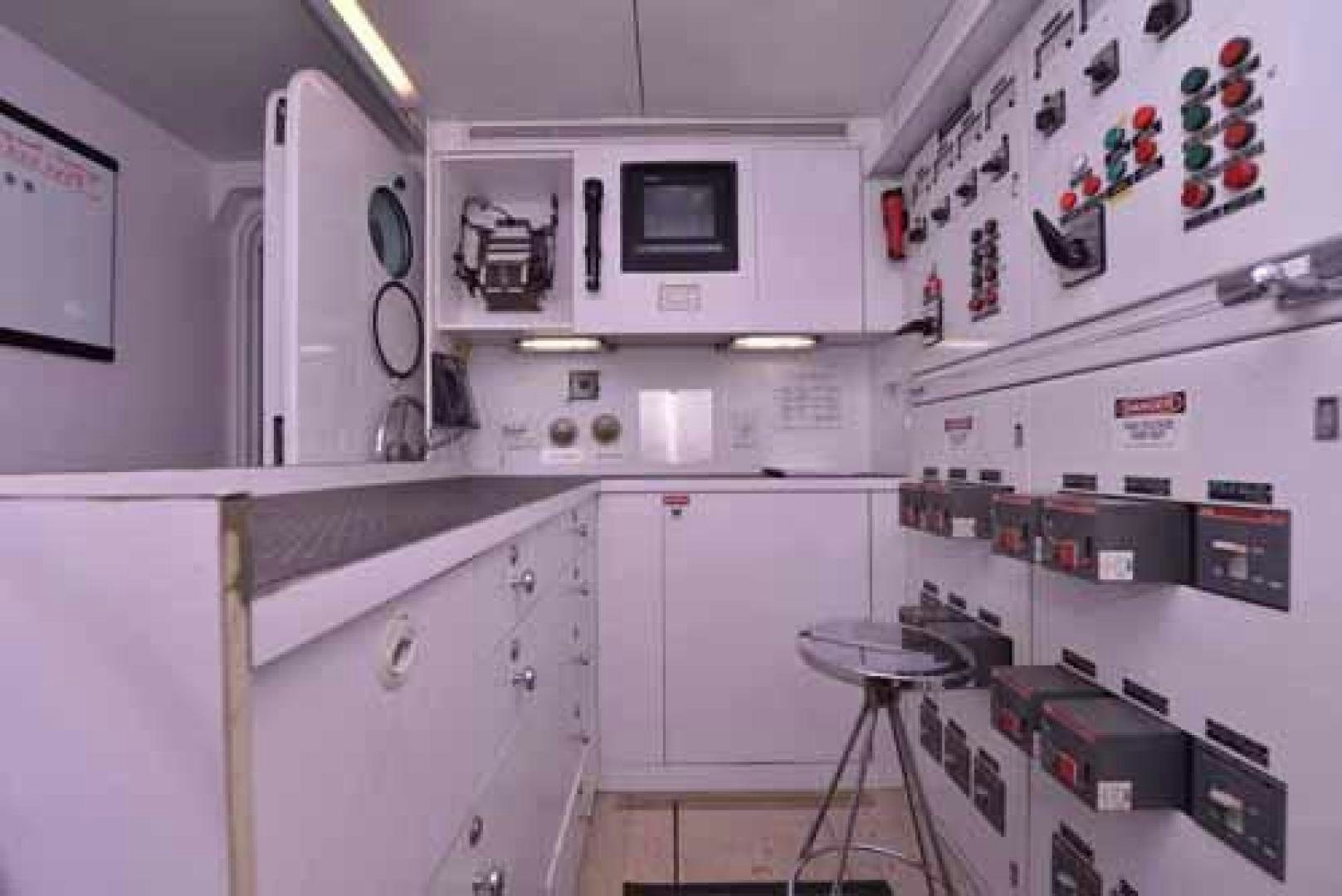a kitchen with white cabinets aboard UTOPIA III Yacht for Sale