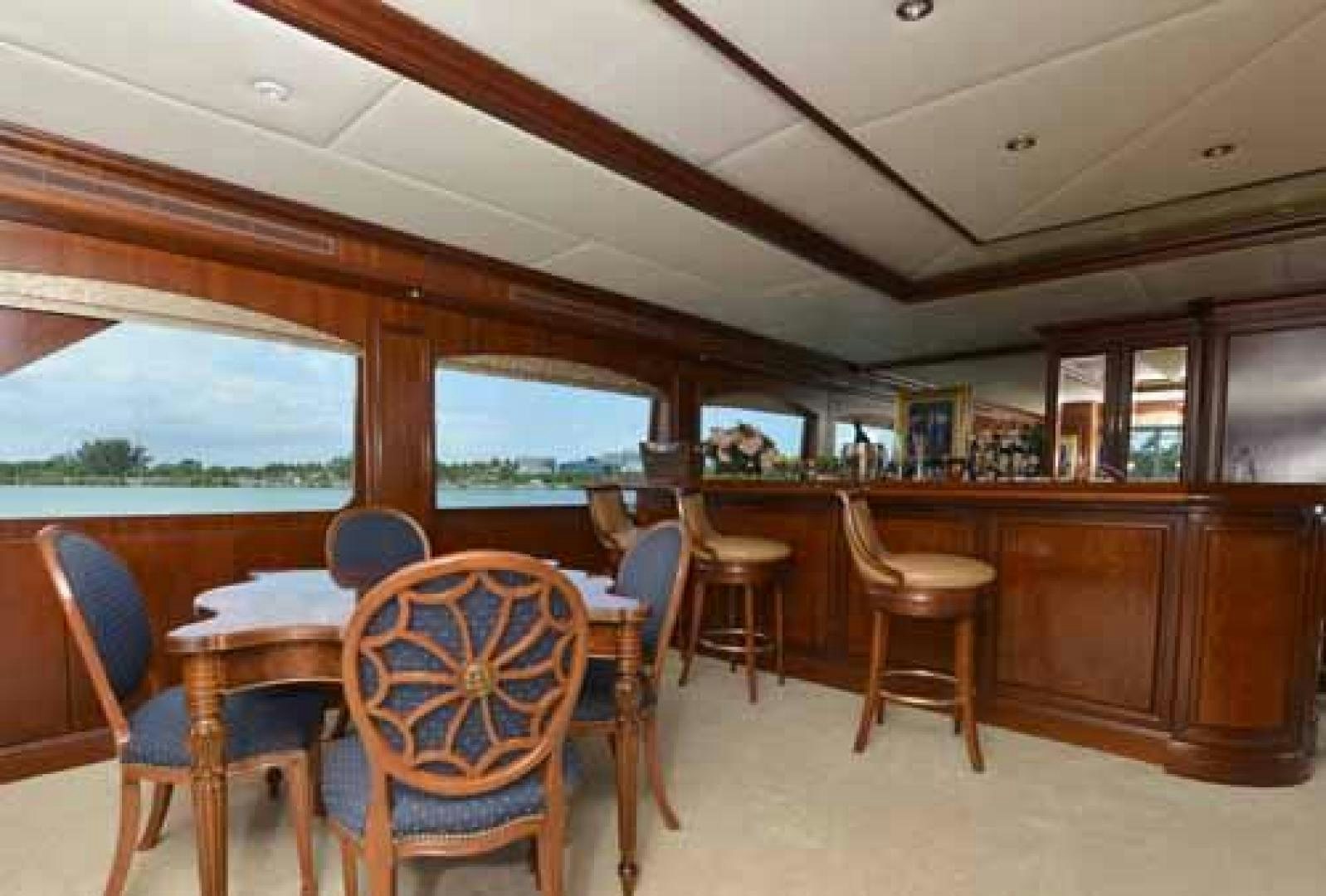 a restaurant with tables and chairs aboard UTOPIA III Yacht for Sale
