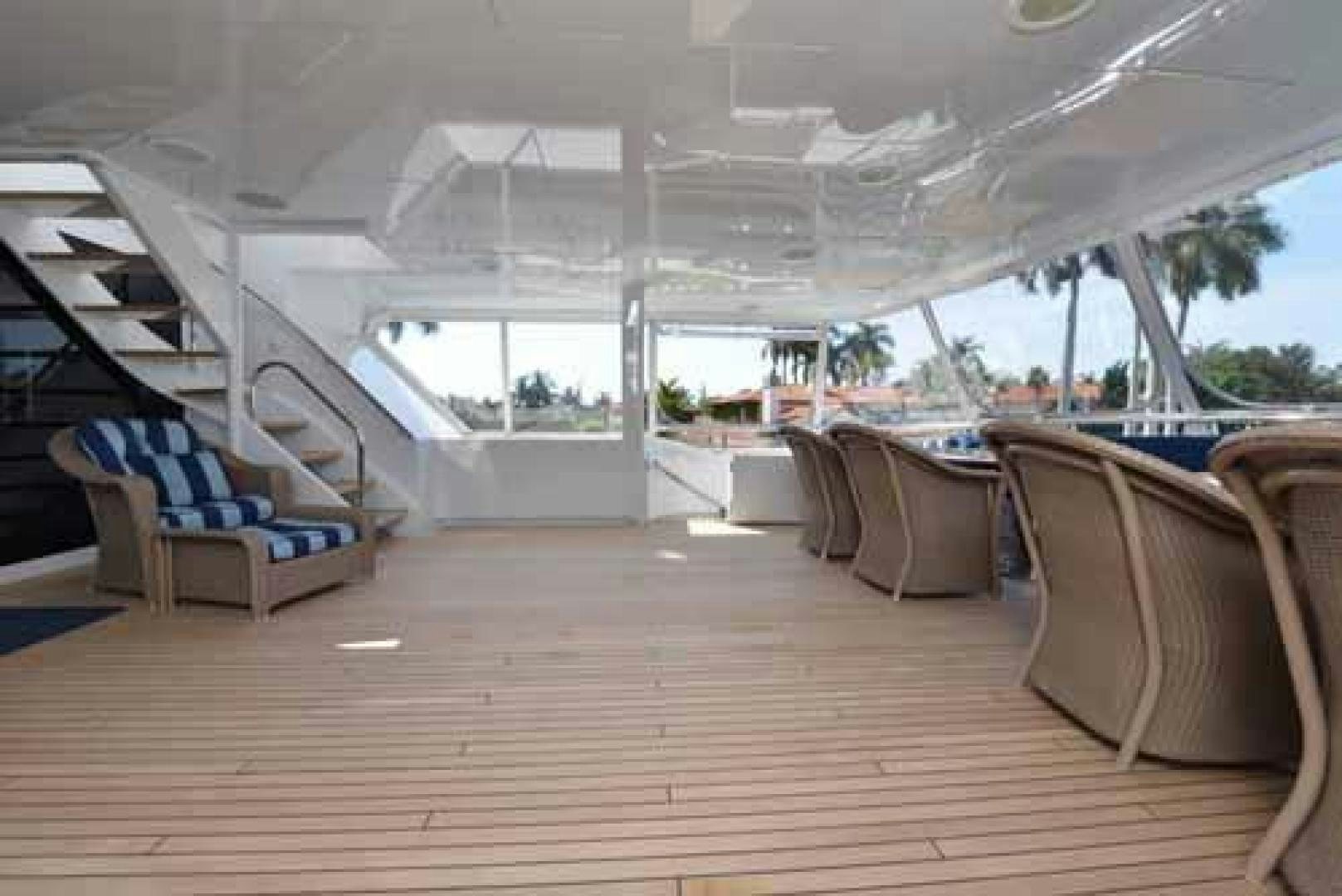 a room with a wood floor and a wood floor and a staircase aboard UTOPIA III Yacht for Sale