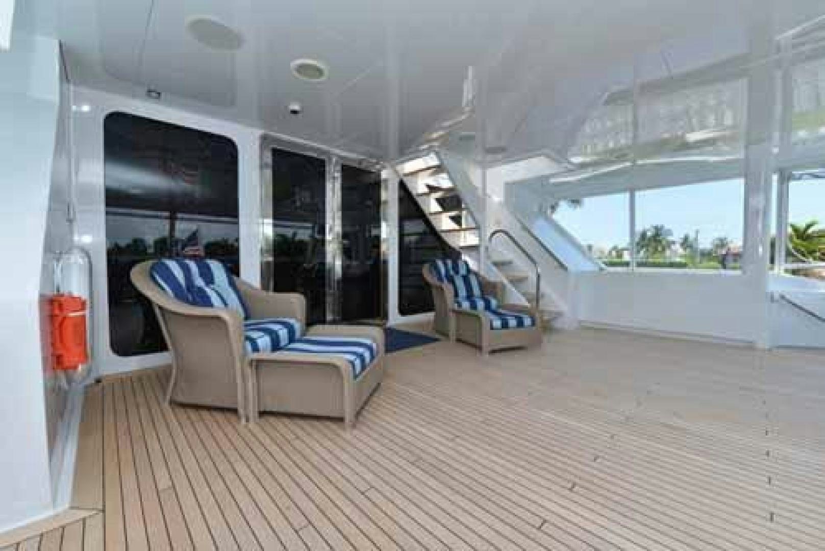 a room with a couch and a wood floor aboard UTOPIA III Yacht for Sale