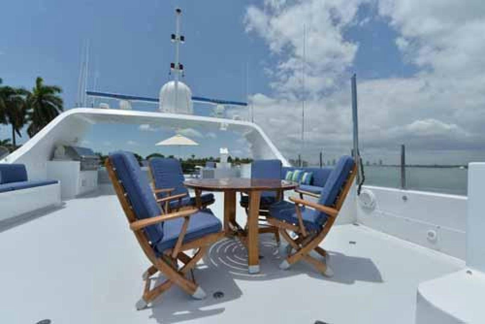 a table and chairs on a beach aboard UTOPIA III Yacht for Sale